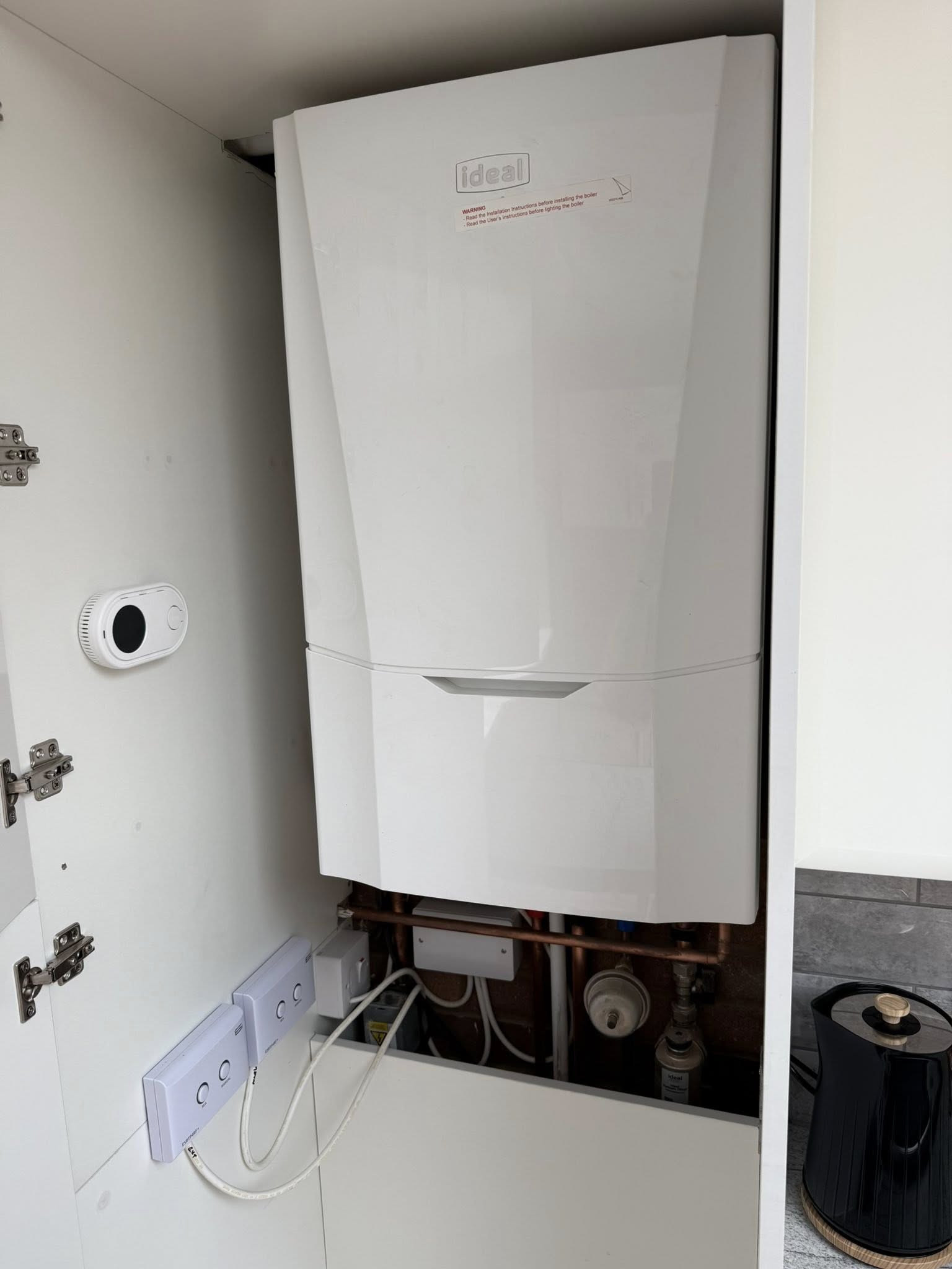 Ideal boiler installation in kitchen cupboard