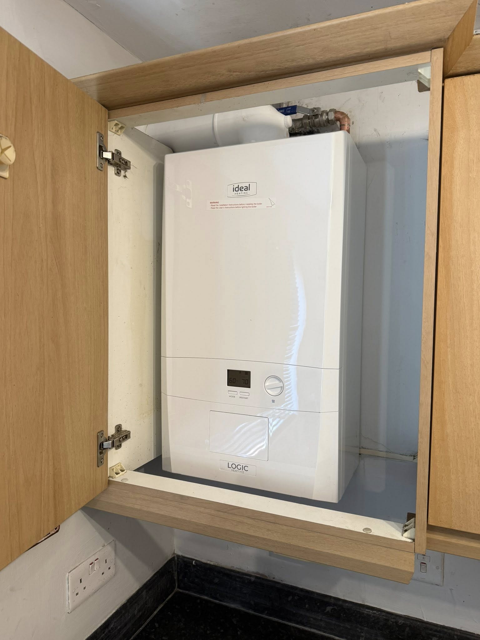 Ideal Logic boiler fitted in oak cabinet